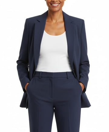 Person wearing a navy suit with a white top on a white background